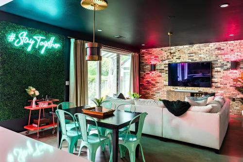 a living room with a couch and a table at Pool and Hot Tub Retreat Near Rainey in Austin