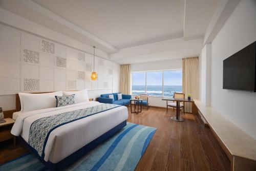 a hotel room with a bed and a television at Fortune Beachfront, Puri - Member ITC Hotels' Group in Puri