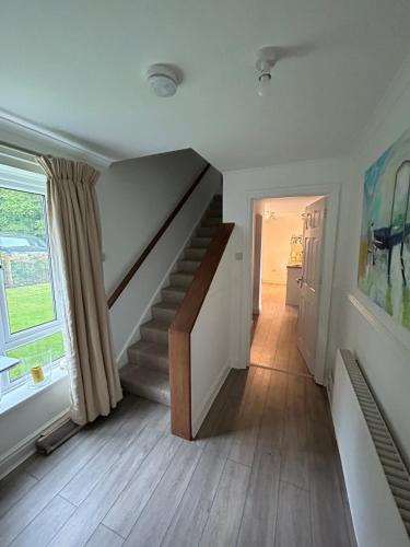 a hallway with a staircase in a house at The Forge in Avington