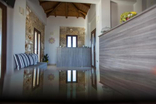 a hallway with a table and a couch in a room at Tramonto Suites in Xi