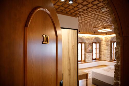 a door to a room with a bed and a bedroom at Hotel Kashah in Gjirokastër