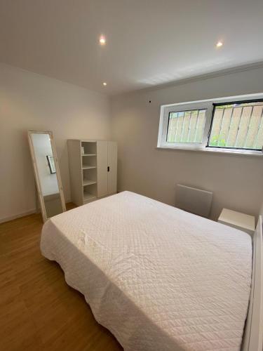 a bedroom with a large bed and a window at Maresia BIKE ROOMS in São Félix da Marinha
