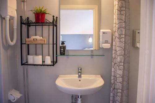 a bathroom with a sink and a mirror at Villa Storfors in Storfors