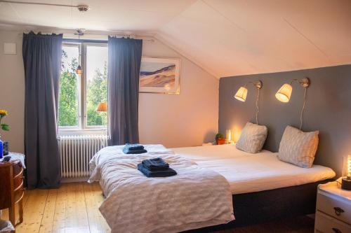 a bedroom with two beds and a window at Villa Storfors in Storfors