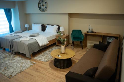 a bedroom with a bed and a couch and a table at Hotel Darina Select in Târgu-Mureş