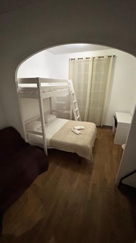a bedroom with a bunk bed with a ladder at Victor Hugo's Le Central in Saint-Junien