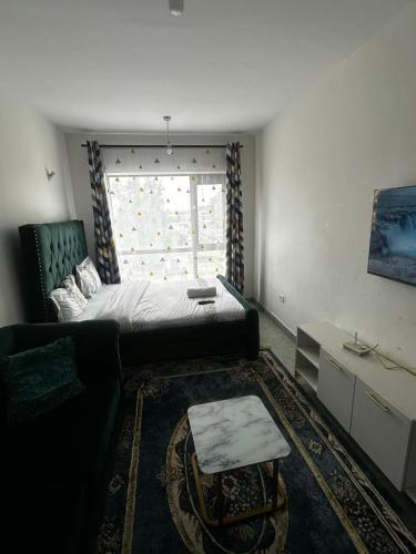 a living room with a bed and a window at Tsavo in Nairobi