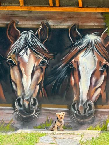 a painting of three horses on a wall at Вила Рози, Семково in Belitsa