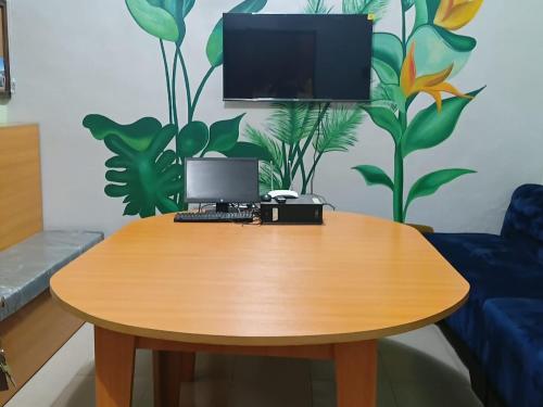 a wooden table with a computer on top of it at Engelbert Beyer Centre in Ibadan