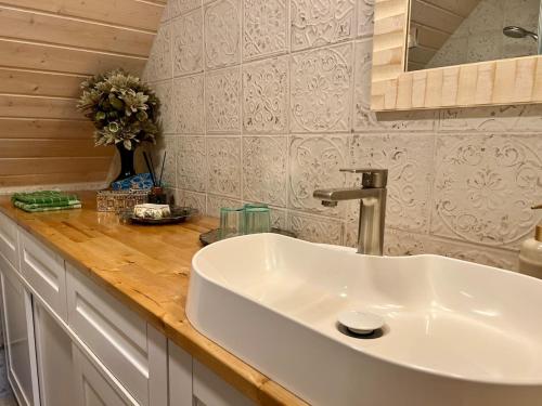 a bathroom with a white sink and a counter at Countryhome apartment in Jõõpre