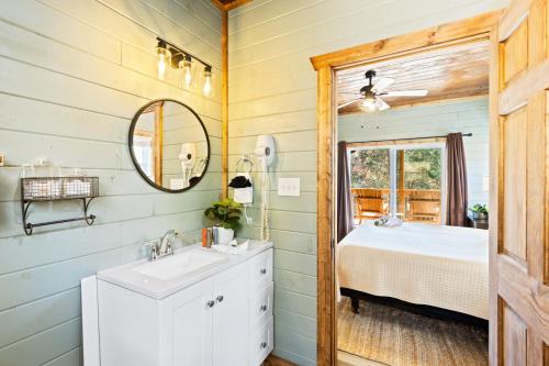 a bathroom with a sink and a mirror at Luxe Mountain Pool Escape by Ghosal Luxury Lodging in Gatlinburg