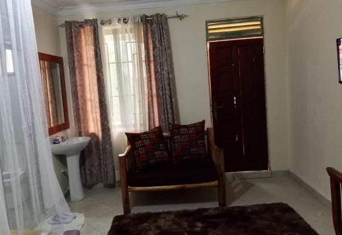 a bathroom with a chair and a sink and a window at Luanda Road View Hotel in Luanda