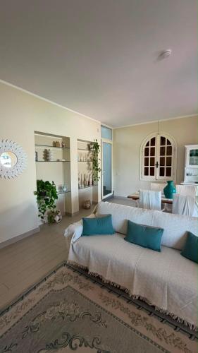 a large bedroom with two beds with blue pillows at Villa Anna in Quartu SantʼElena