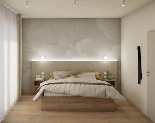 a bedroom with a large bed and a wall at Gezeiten Suites Büsumer Deichhausen - Neueröffnung in Büsumer Deichhausen