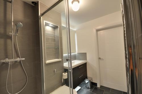 a bathroom with a shower and a sink at The Garden Apartment, Near Airport & City in Manchester