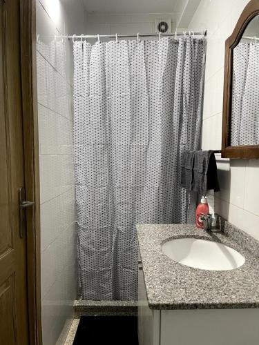 a bathroom with a shower curtain and a sink at Flat with nice view in Gualtar, Braga in Braga