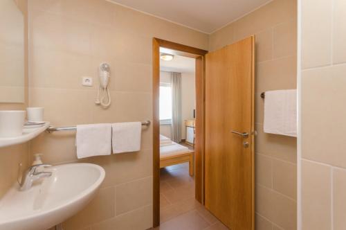 a bathroom with a sink and a toilet at Zimmer Katarina in Vodice