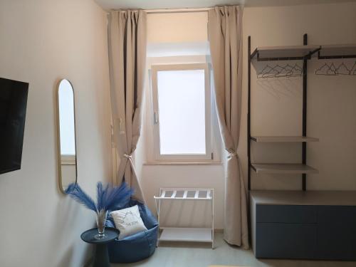 a dressing room with a window and a mirror at The Dome in Orbetello