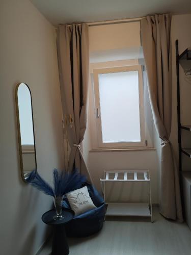 a room with a mirror and a chair and a window at The Dome in Orbetello