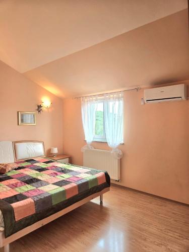 a bedroom with a bed and a window at Apartments Coral, Klimno, island Krk in Klimno