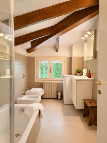 a bathroom with two toilets and a sink and a tub at Garden Loft by Veneto Villa in Albignasego