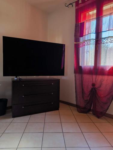a flat screen tv sitting on a dresser next to a window at Apartment with three double bedrooms in Altavilla Vicentina