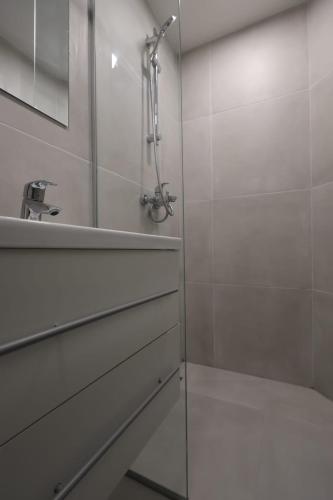 a bathroom with a shower and a sink at Downtown Condo w Huge TV in Zagreb
