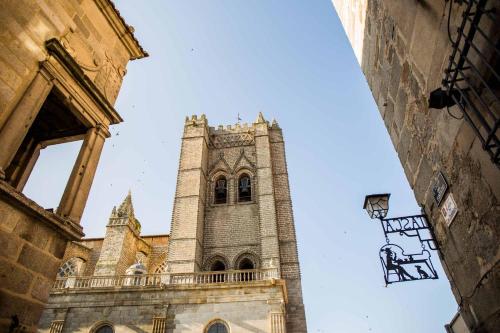 a tall building with a clock tower in the distance at Palacio de los Velada in Avila