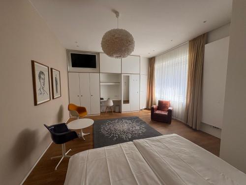 a bedroom with a bed and a living room at ART Hotel Ufer in Düsseldorf
