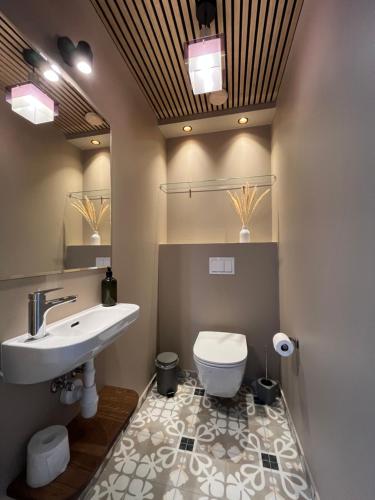 a bathroom with a sink and a toilet at Villa Eha in Kuressaare