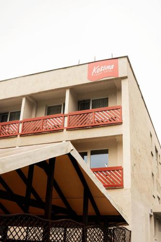 a building with a balcony with a koya sign on it at Kotlina smart hotel in Rožňava