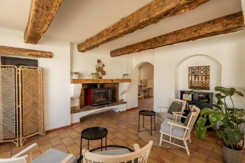 a living room with a fireplace and chairs at L'Oustau des Palunettes Concept Adulte only in Saintes-Maries-de-la-Mer