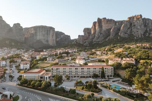 a view of a city with mountains in the background at Divani Meteora Hotel in Kalabaka