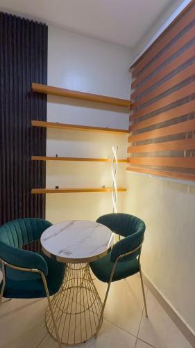 a room with a table and two chairs at Affar homes in Kumasi