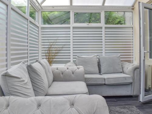 a living room with a couch and a window at Huddersfield House, Wood View in Huddersfield