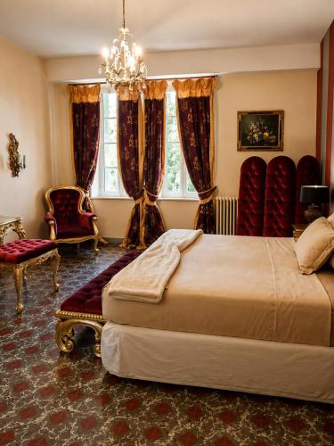a bedroom with two beds and a chandelier at Château de Lavail in Labastide-dʼAnjou