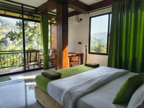 a bedroom with a bed with green curtains and windows at Ella Mount Relax Cottage in Ella
