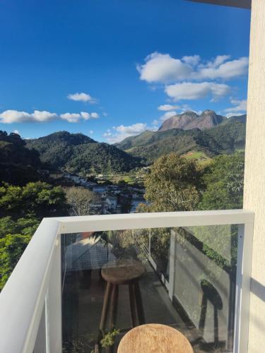 a balcony with a view of the mountains at Treetops Home in Teresópolis