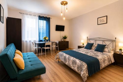 a bedroom with a bed and a couch and a table at Szept Fal & Minigolf in Rewal