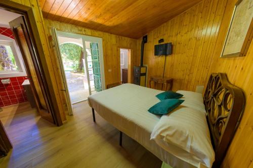a bedroom with a bed in a room with wooden walls at Villa dei Papi Subiaco in Subiaco
