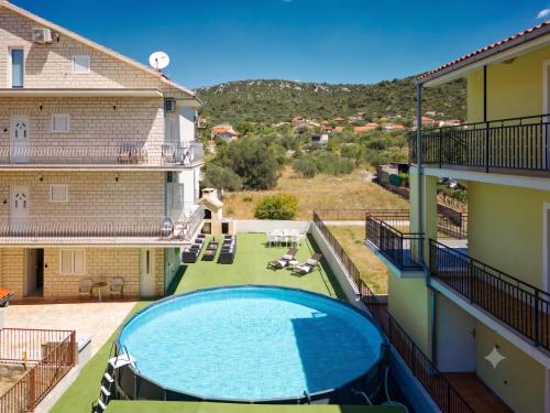 a swimming pool in the middle of a building at Sun Spalato Mastrinka in Vinišće