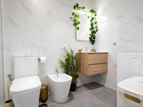 a bathroom with a white toilet and a sink at Dream Ocean Sunset in Playa Paraiso