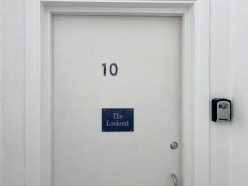 a door with a sign that reads the laboratory at The Lookout in Sennen