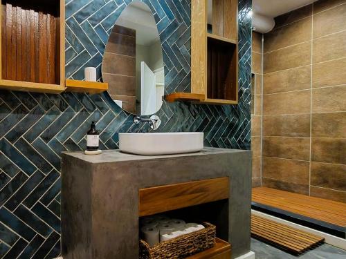 a bathroom with a sink and a mirror at Eternal @ Yzerfontein in Yzerfontein