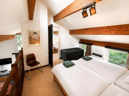 a bedroom with two beds and a desk and a chair at Havane13 in Hastière-par-delà