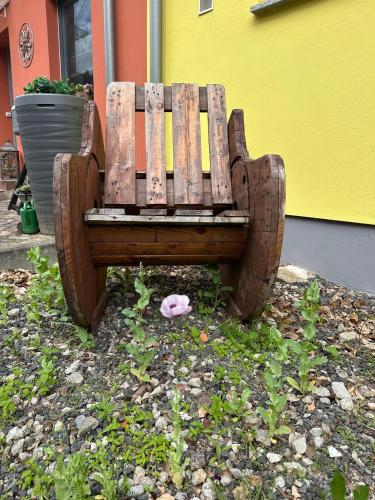a wooden bench sitting next to a building at Vorsicht Hôtel in Deyelsdorf