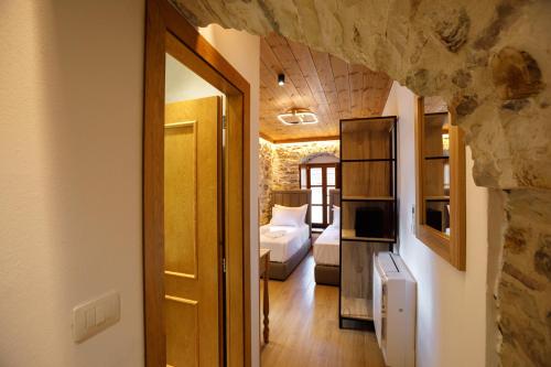 a room with a bedroom with a bed and a door at Hotel Kashah in Gjirokastër