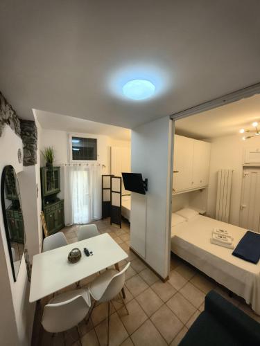 a small room with a bed and a table and chairs at Manarola Sunset House in Manarola