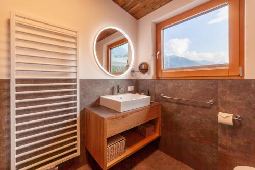a bathroom with a sink and a mirror at Krebishof Agriturismo in Schenna