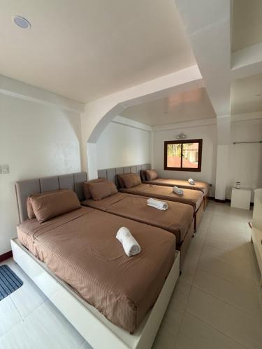 a bedroom with two beds in a room at Villa Virtud Beach Resort in Alegria